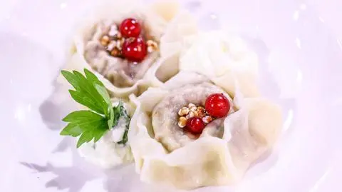 Pierogi z kaszą gryczaną, twarogiem, ziemniakami, skwarkami z lubczykiem, podawane ze śmietaną z lubczykiem